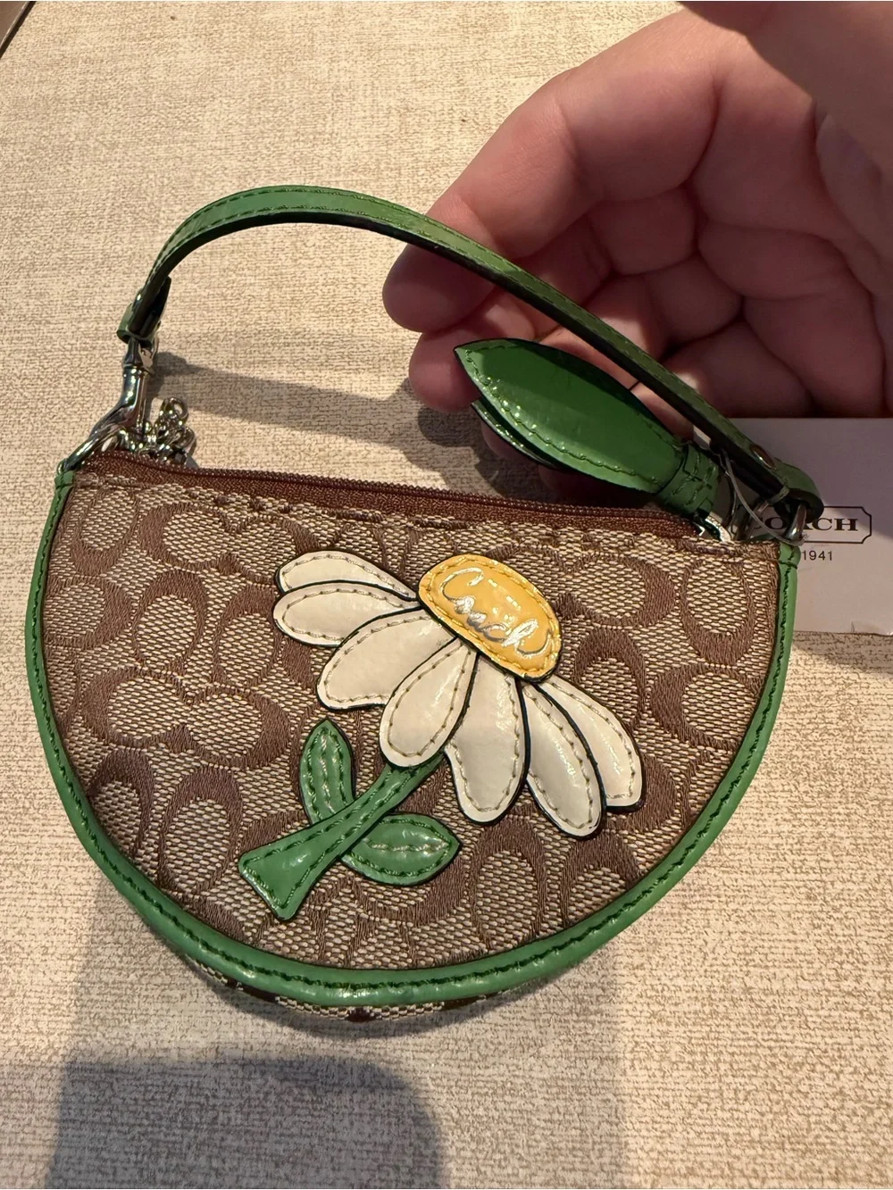 Coach Brown Signature Wristlet with Green Trim and Daisy Motif